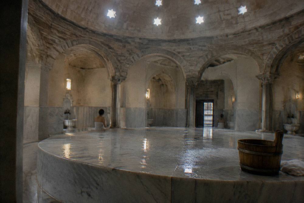 Steamy hot room of a Turkish bath with a large warmed marble platform