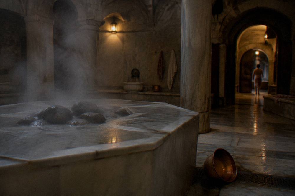 Steam rising from hot stones in a dim wooden steam bath room