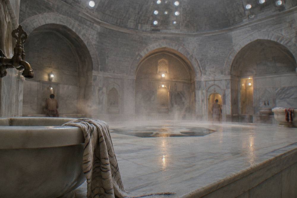 Steam rising over a heated marble platform inside a domed hammam hot room