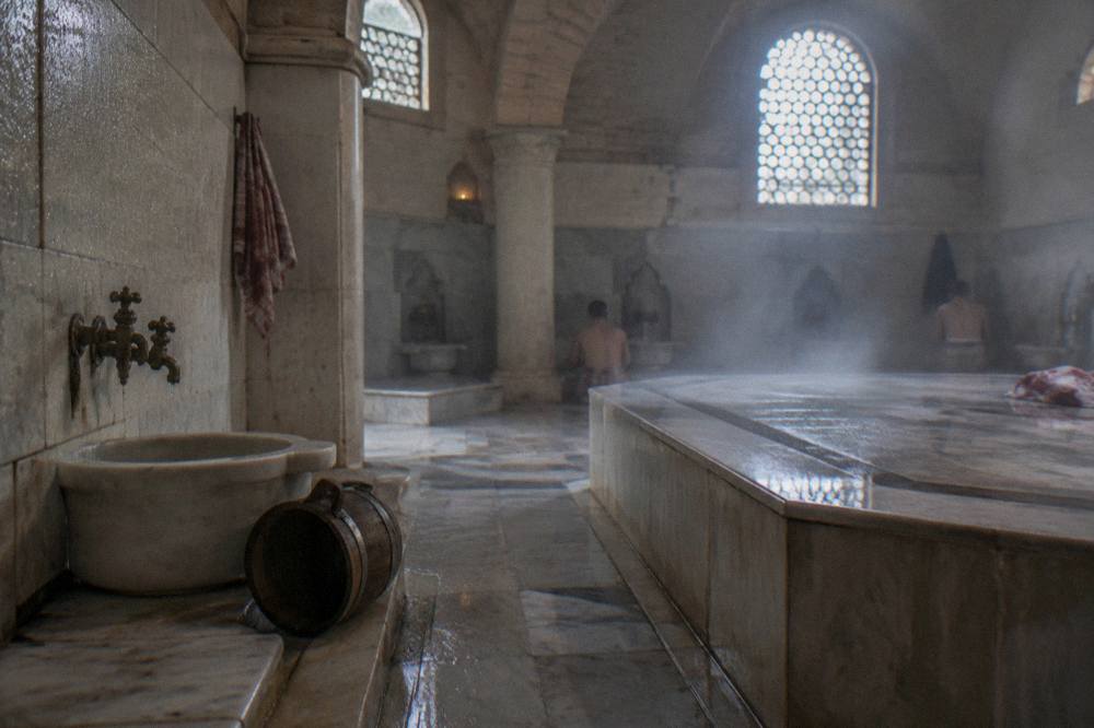 Domed hammam hot room with a large heated marble platform and rising steam