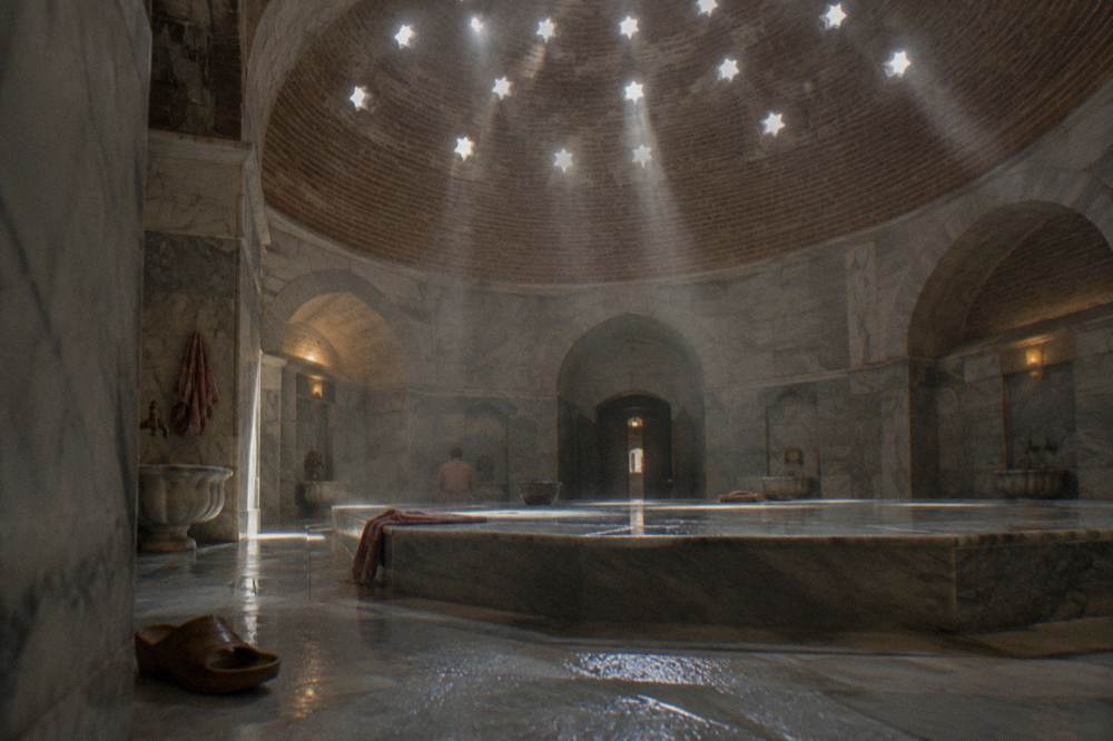 Private hammam interior with a domed ceiling and a tiled bathing platform