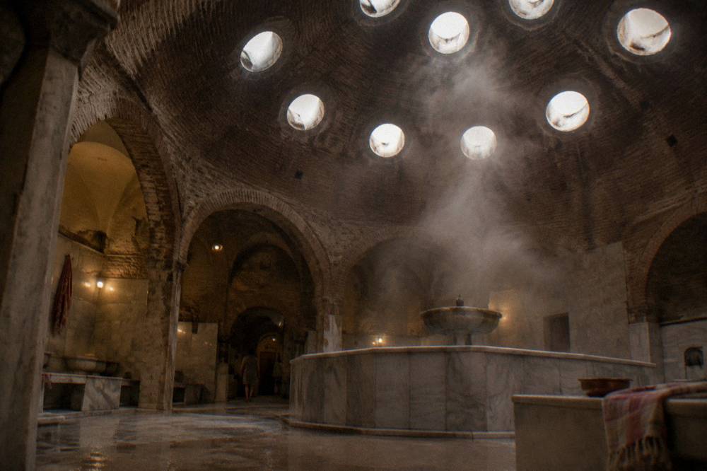 Round glass skylights in the dome of an Ottoman bath house over steam