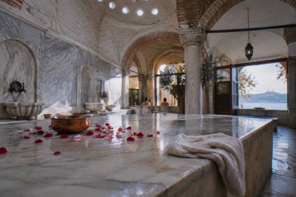 Warm marble bathing platform in a hammam hot room with a domed ceiling above