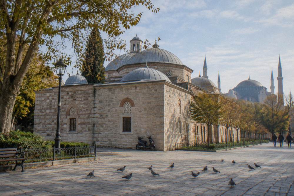 Exterior stone walls and domes of a historic Istanbul bathhouse in daylight