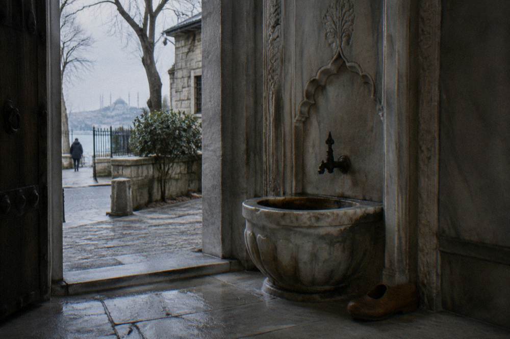 Carved marble doorway and worn stone basin inside a historic Istanbul bathhouse