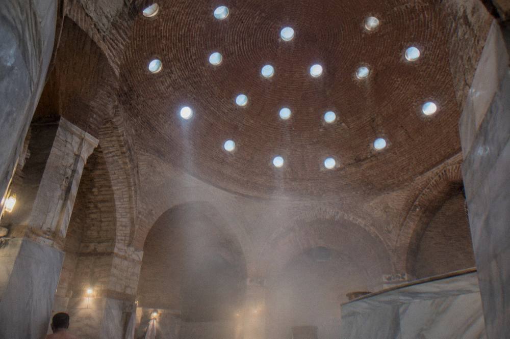 Domed ceiling of a historic Turkish bath with small glass circles letting in light