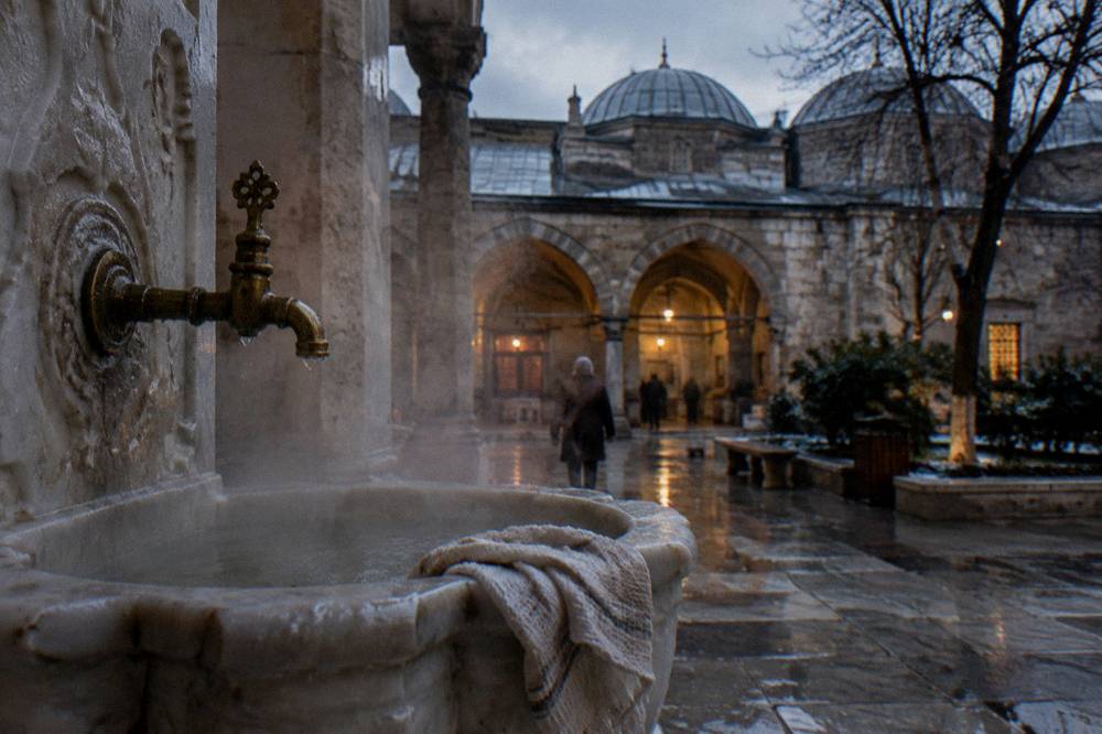 Steam drifting across the carved marble basin of a Turkish bath