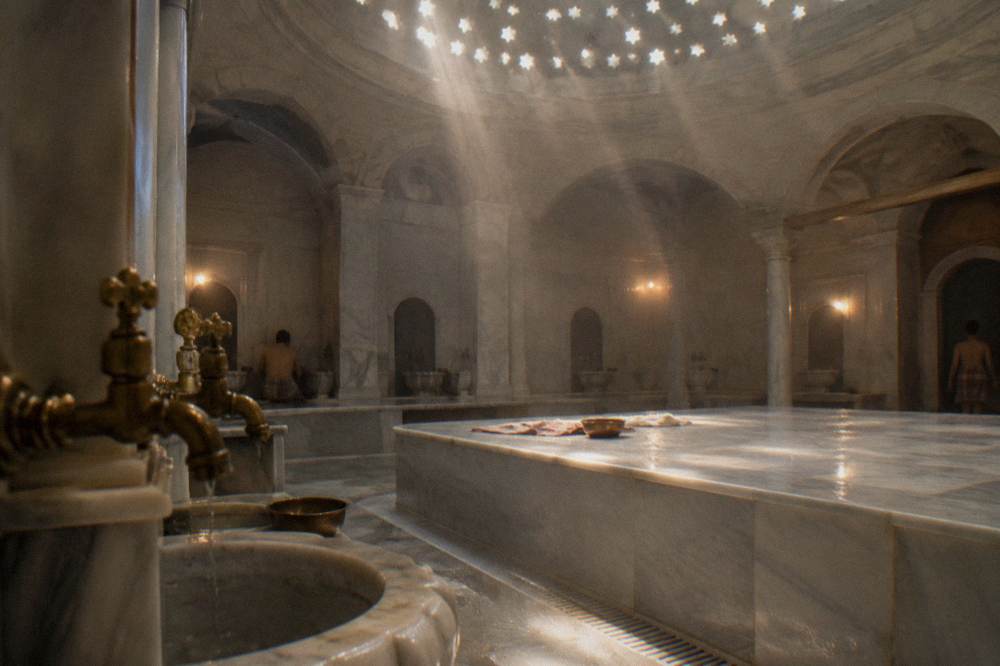 Hot room of an Ottoman bath with a large heated marble slab and brass taps over stone basins