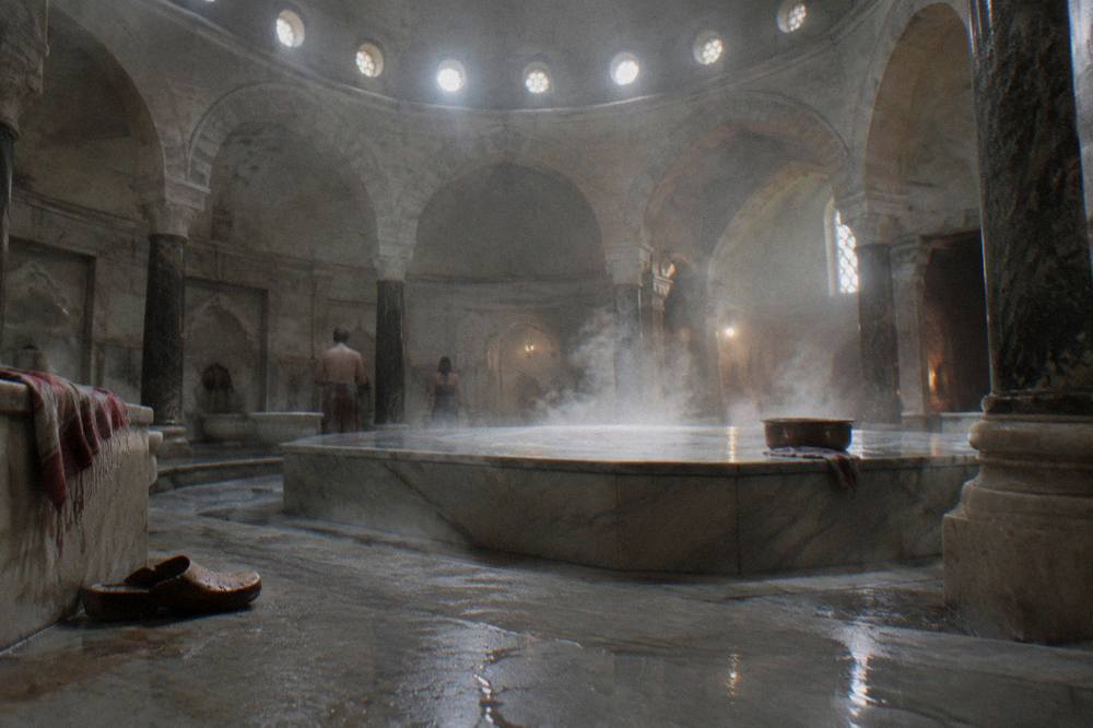 Warm steam drifting through a domed marble bath hall with a raised stone platform