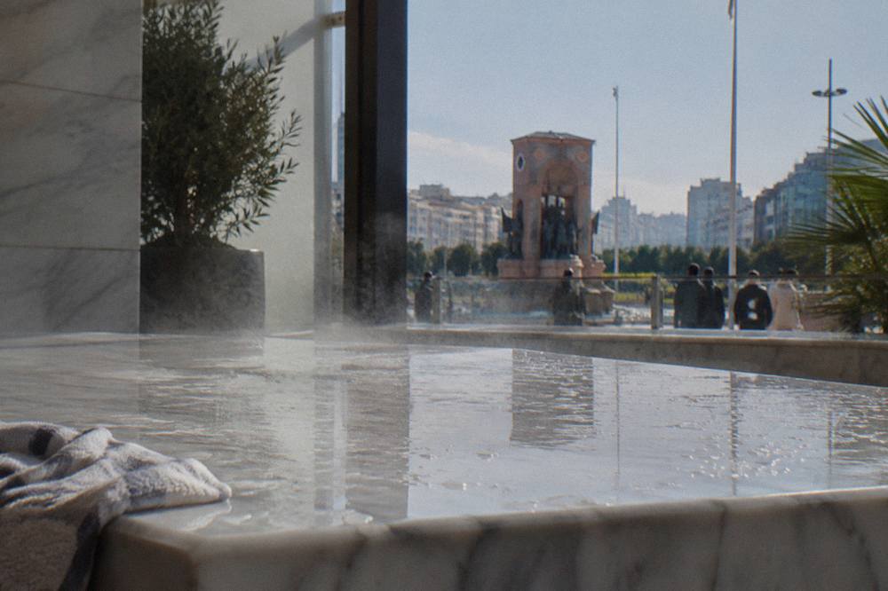 Steam rising from a heated marble slab under a domed skylight