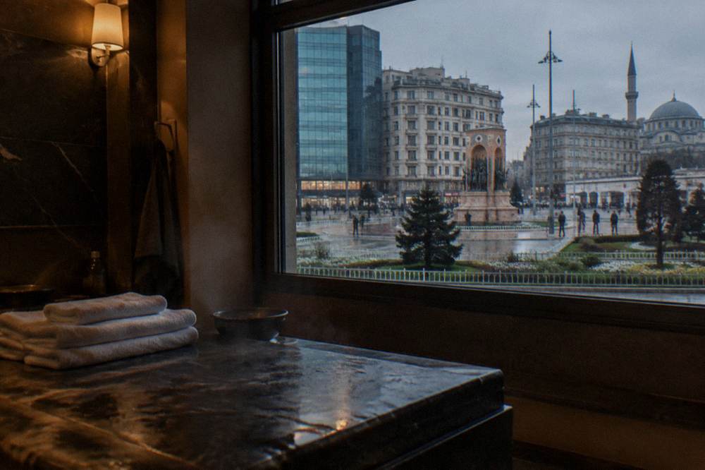 Spa treatment room with a heated stone slab, folded towels and soft lighting