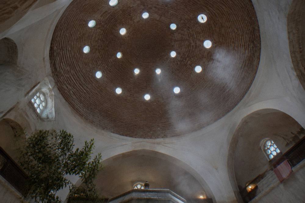 Domed ceiling of an Ottoman bathhouse pierced with small round glass eyelets