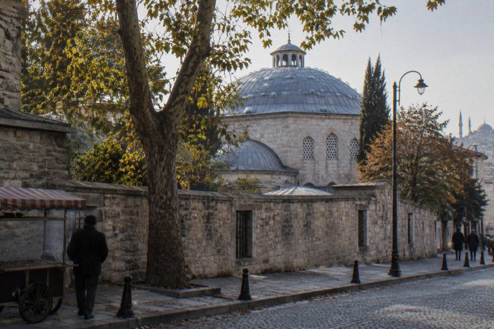 Stone exterior of an Ottoman bathhouse with a domed roof and small glass lights set into the masonry