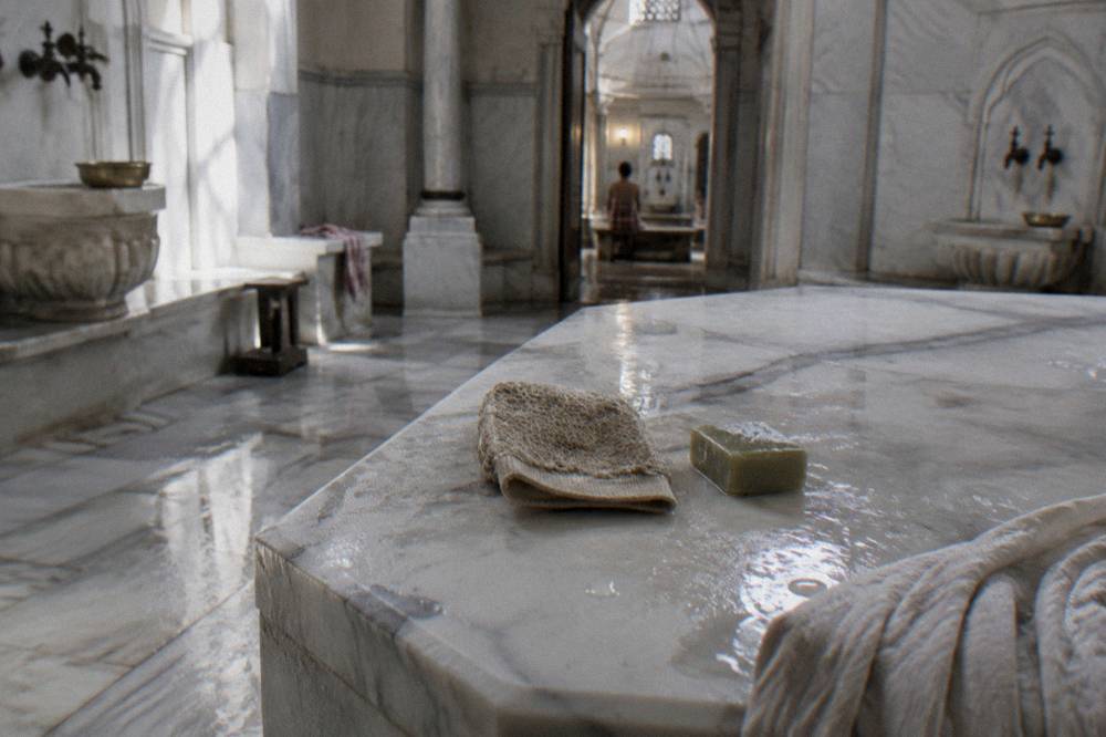 Attendant's kese mitt and olive soap on a marble hamam bench