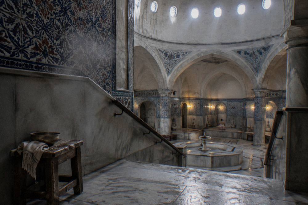 Domed ceiling of a restored Ottoman bathhouse with glass openings casting light onto tiled walls